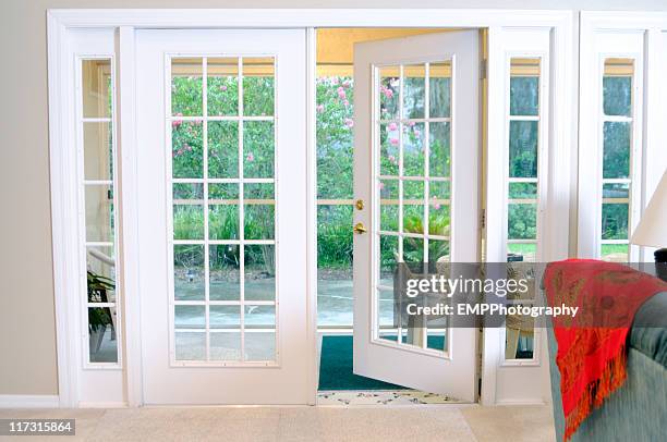 open white french doors without curtains - terrasdeur stockfoto's en -beelden