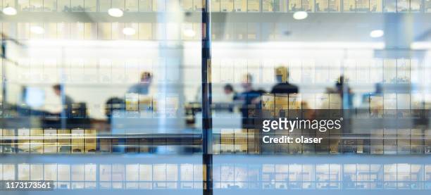 workers working late. tall building reflected - enterprise stock pictures, royalty-free photos & images