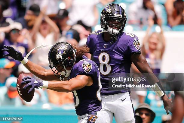 Willie Snead of the Baltimore Ravens celebrates with Lamar Jackson after scoring a touchdown against the Miami Dolphins during the second quarter at...