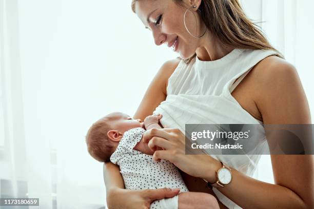 breastfeeding and holding newborn baby - baby girl eyes stock pictures, royalty-free photos & images