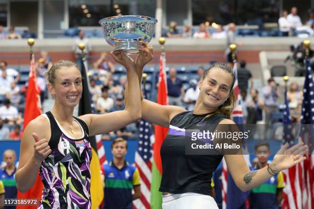 Elise Mertens of Belgium and Aryna Sabalenka of Belarus pose with the trophy after winning their Women's Double's final match against Victoria...