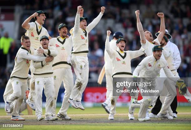 Australia celebrate the final wicket of Craig Overton of England to win the Test Match and retain the Ashes during Day Five of the 4th Specsavers...