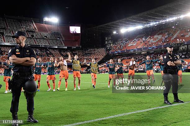 Ajax's players celebrate at the end of the UEFA Champions League Group H football match between Valencia and Ajax at the Mestalla stadium in Valencia...