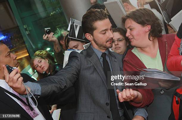 Actor Shia LaBeouf takes a snapshot with a fan as he attends the "Transformers 3" European premiere on June 25, 2011 in Berlin, Germany.