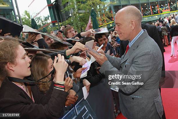 Actor John Malkovich signs autographs as he attends the "Transformers 3" European premiere on June 25, 2011 in Berlin, Germany.
