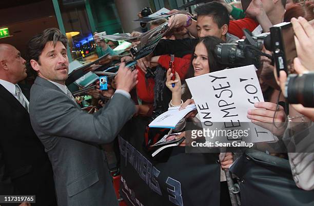 Actor Patrick Dempsey signs autographs for fans as he attends the "Transformers 3" European premiere on June 25, 2011 in Berlin, Germany.