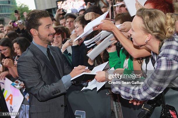Actor Shia LaBeouf sign autographs as he attends the "Transformers 3" European premiere on June 25, 2011 in Berlin, Germany.