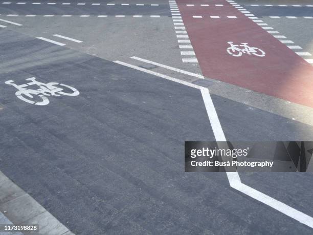 road markings on bike lanes in barcelona, spain - barcelona street stock-fotos und bilder