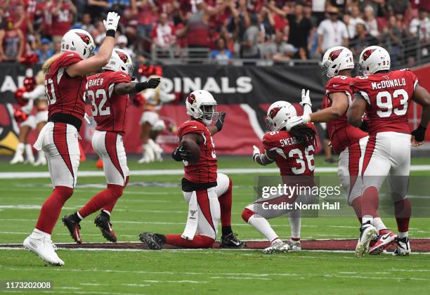 Chandler Jones of the Arizona Cardinals celebrates with DJ Swearinger Sr, Budda Baker and teammates after recovering a fumble during the first...