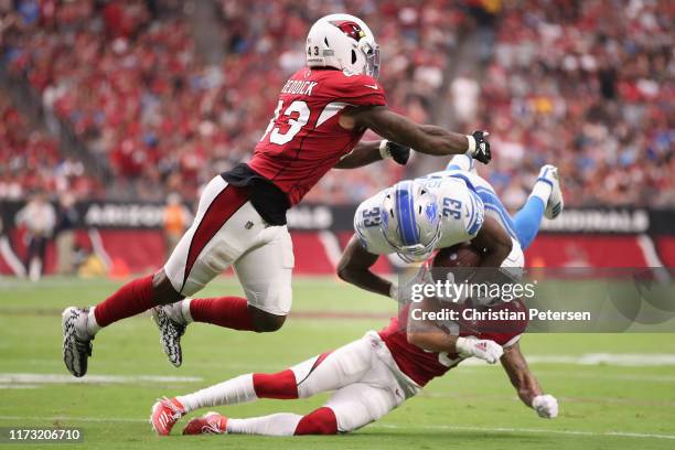 Running back Kerryon Johnson of the Detroit Lions is tackled by Byron Murphy and Haason Reddick of the Arizona Cardinals d1uring the first half of...