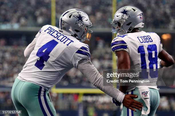 Quarterback Dak Prescott of the Dallas Cowboys celebrates with wide receiver Randall Cobb during the second quarter of the game against the New York...