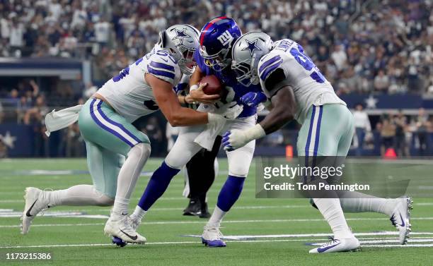 Eli Manning of the New York Giants is sacked by Leighton Vander Esch of the Dallas Cowboys and Demarcus Lawrence of the Dallas Cowboys in the third...