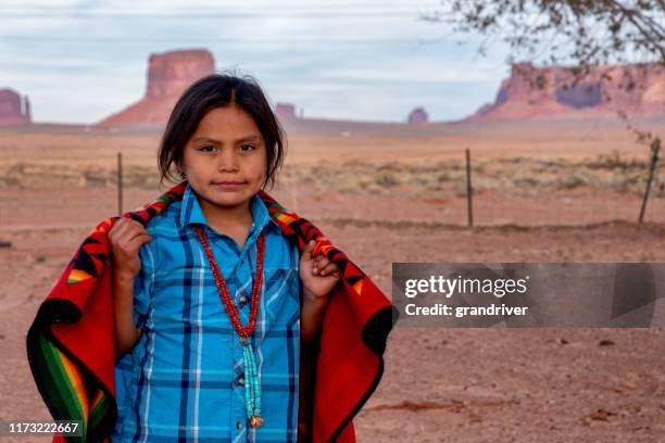 little navajo boy in his yard on the navajo indian reservation in monument valley arizona - apache indian stock pictures, royalty-free photos & images