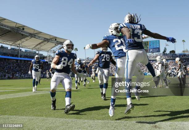 Nyheim Hines and T.Y. Hilton of the Indianapolis Colts celebrate Hilton's touchdown against the Los Angeles Chargers in the fourth quarter at Dignity...