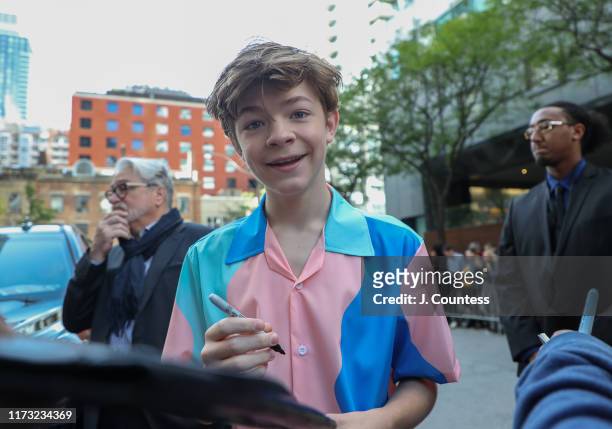 Oakes Fegley signs autographs for fans on the streets of Toronto during the 2019 Toronto International Film Festival on September 08, 2019 in...