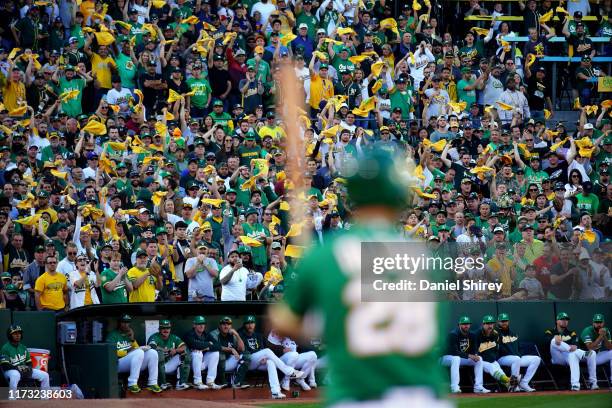 Fans are seen waving rally towels during the AL Wild Card game between the Tampa Bay Rays and the Oakland Athletics at Oakland Coliseum on Wednesday,...