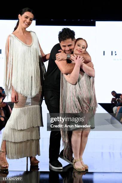Madeline Stuart walks the runway with a designer and model during IBRAINA At New York Fashion Week Powered by Art Hearts Fashion NYFW September 2019...