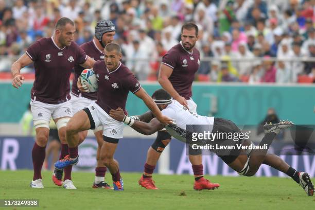Lasha Khmaladze of Georgia is tackled by Semi Kunatani of Fiji during the Rugby World Cup 2019 Group D game between Georgia and Fiji at Hanazono...