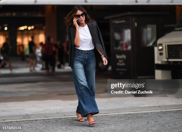 Guest is seen wearing a black jacket, white shirt and blue jeans outside the Jason Wu show during New York Fashion Week S/S20 on September 08, 2019...