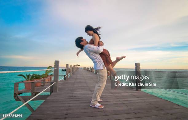 couple on the bridge of beautiful island - honeymoon stock-fotos und bilder