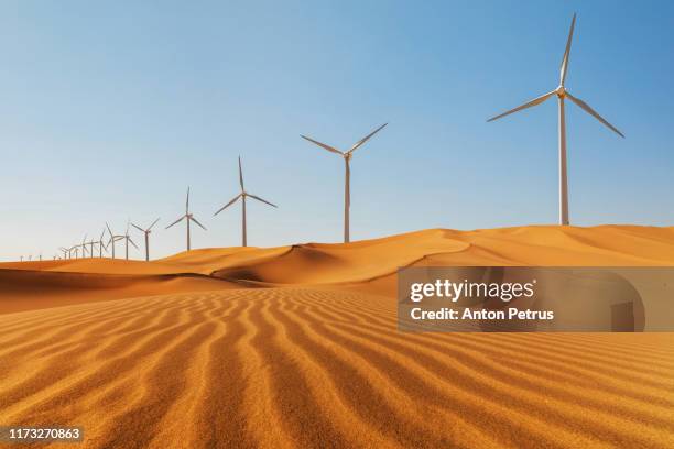 wind turbines in desert at sunset. green energy concept - egypt desert stock pictures, royalty-free photos & images