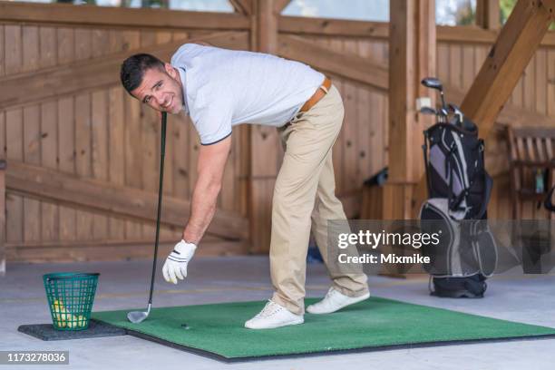 man learning to play golf at the simulator - golf simulator stock pictures, royalty-free photos & images