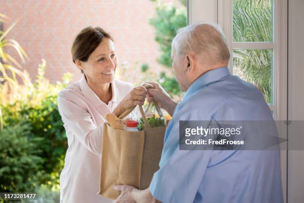 home caregiver – woman helping senior man - volunteer aged care stock pictures, royalty-free photos & images
