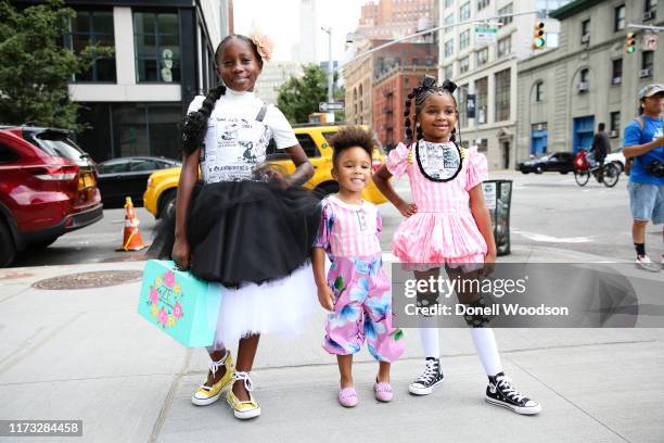 Three young children pose outside of Spring Studios during New York Fashion Week on September 08, 2019 in New York City.