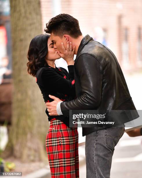 Lucy Hale and Zane Holtz kiss while filming on location for 'Katy Keene' on the streets of Brooklyn on October 2, 2019 in New York City.