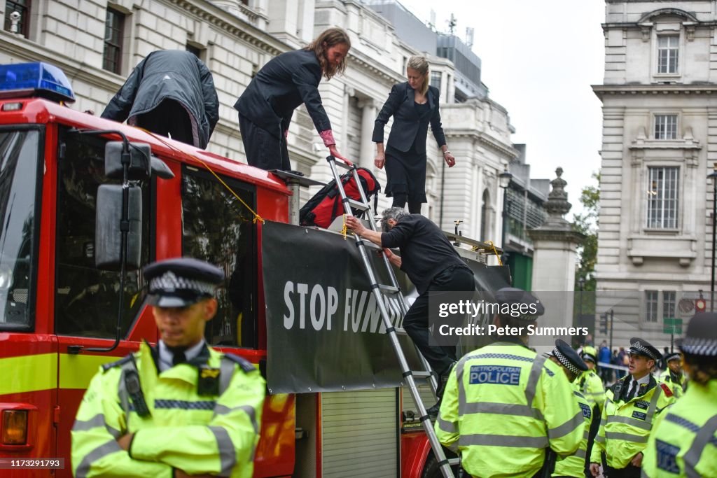 Climate Change Protesters Use A Fire Engine To Spray Fake Blood Onto The Treasury Building
