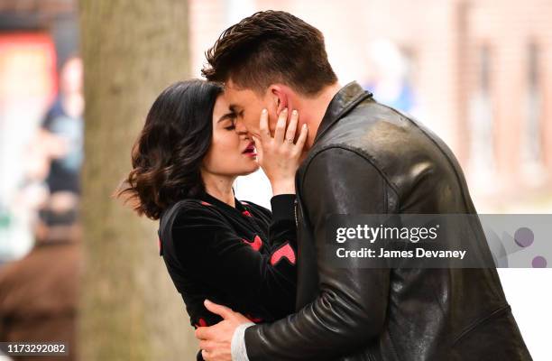 Lucy Hale and Zane Holtz kiss while filming on location for 'Katy Keene' on the streets of Brooklyn on October 2, 2019 in New York City.
