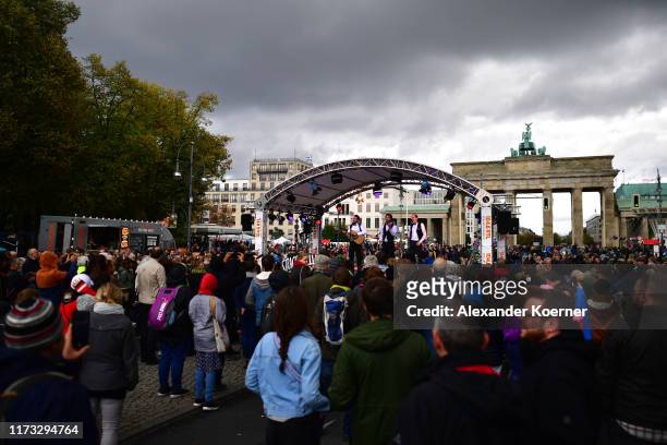 People walk near the Brandenburg Gate during celebrations on German Unity Day on October 3, 2019 in Berlin, Germany. The day marks the 1990...