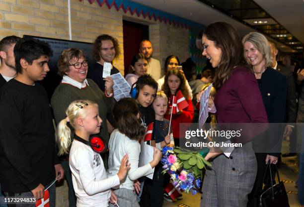 Crown Princess Mary of Denmark is welcomed by hundreds of school children during a school visits near Copenhagen where kids work with a project about...
