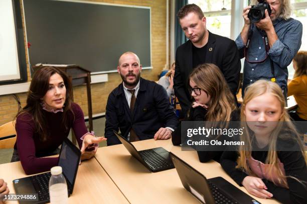 Crown Princess Mary of Denmark is talking to kids in a school class at Frydenhoejskolen near Copenhagen where the kids work with a project about...