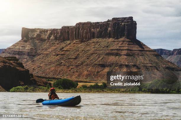 woman rafting with kayak in colorado river, moab - moab rafting stock pictures, royalty-free photos & images