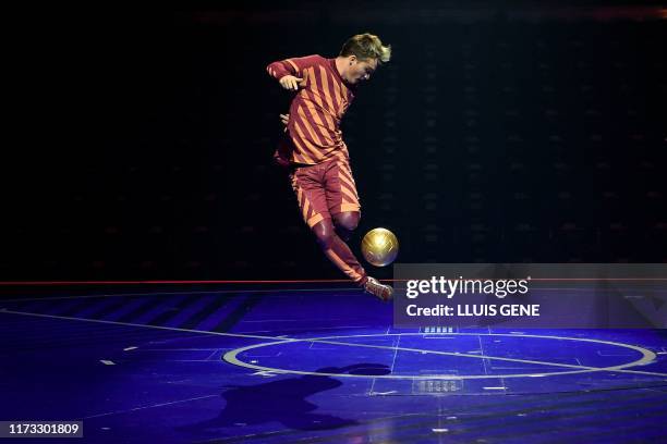 An artist of the Canadian entertainment company "Cirque du Soleil" performs during a rehearsal of the Messi10 show based on the career of Argentinian...