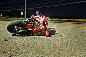 Close-up of wrecked red motorcycle on side of road