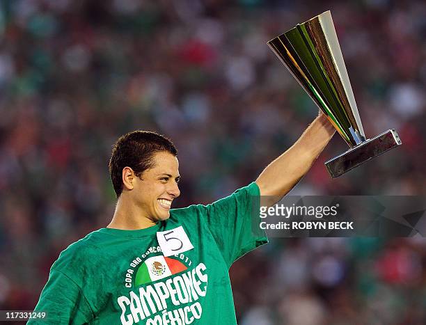 Javier Hernandez of Mexico holds the Most Valuable Player trophy after Mexico defeated USA 4-2 to win the CONCACAF 2011 Gold Cup final June 25, 2011...
