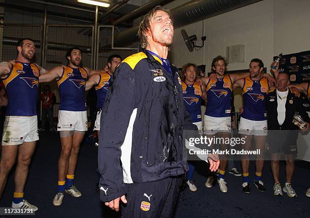 Mark Nicoski of the Eagles celebrates his 100th game as the team sing their song after winning the round 14 AFL match between the Carlton Blues and...