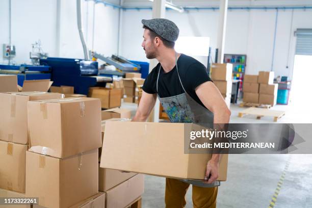 young man holding carboard boxes - moving service imagens e fotografias de stock