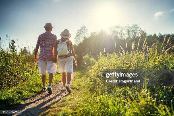 senior couple enjoying hiking in nature - walking trail stock pictures, royalty-free photos & images