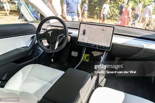 Tesla Model 3 compact full electric car interior with a large touch screen on the dahsboard on display at the 2019 Concours d'Elegance at palace...
