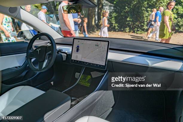 Tesla Model 3 compact full electric car interior with a large touch screen on the dahsboard on display at the 2019 Concours d'Elegance at palace...