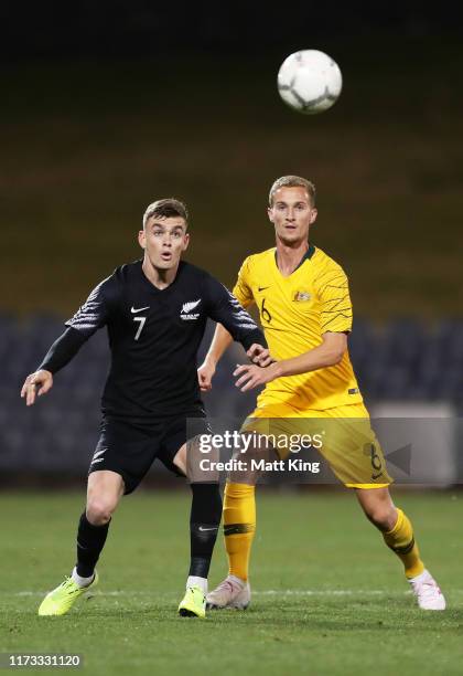 Myer Bevan of New Zealand competes for the ball against Tass Mourdoukoutas of Australia during the International Friendly Match between the...