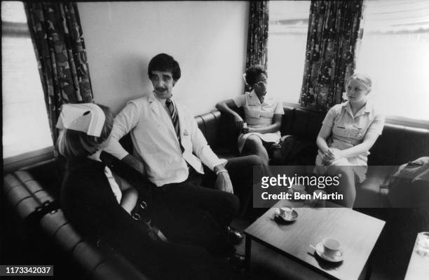 English actor Peter Mayhew , with nurses during a tea break at King's College Hospital, London, where he works as an orderly, 22nd August 1977....