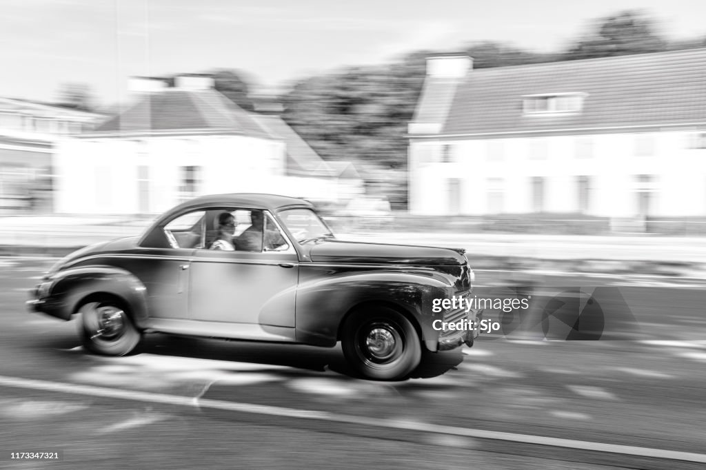 Peugeot 203 Coupe French classic 1950s car driving at high speed on a road through a forest