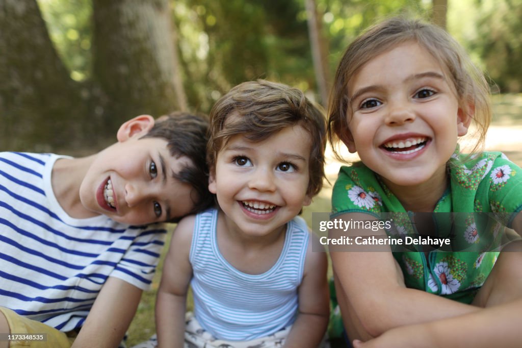 3 brothers and sister posing together in the garden