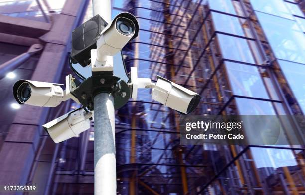 surveillance camera in city - facial recognition technology stock-fotos und bilder