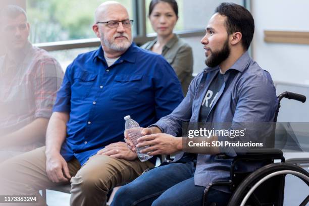 wounded veteran in wheelchair participates in support group - wounded vet stock pictures, royalty-free photos & images