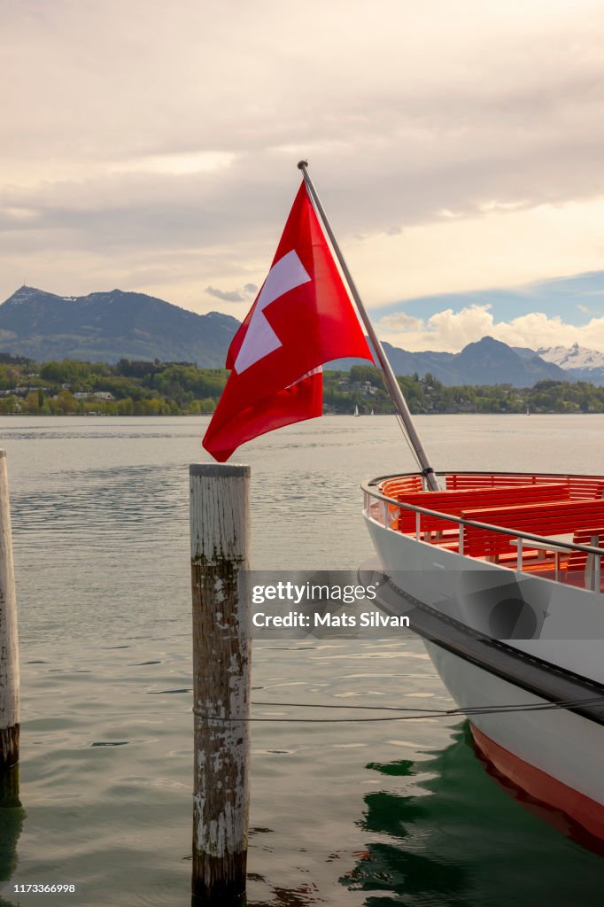 Swiss Flag on a Passenger Ship on Lake Lucerne with Mountain